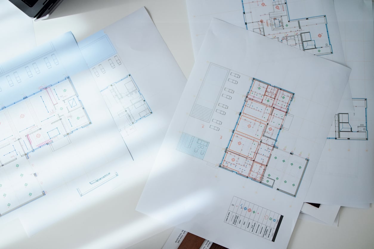 Architectural Floor Plans and Blueprint Documents on Bright Desk